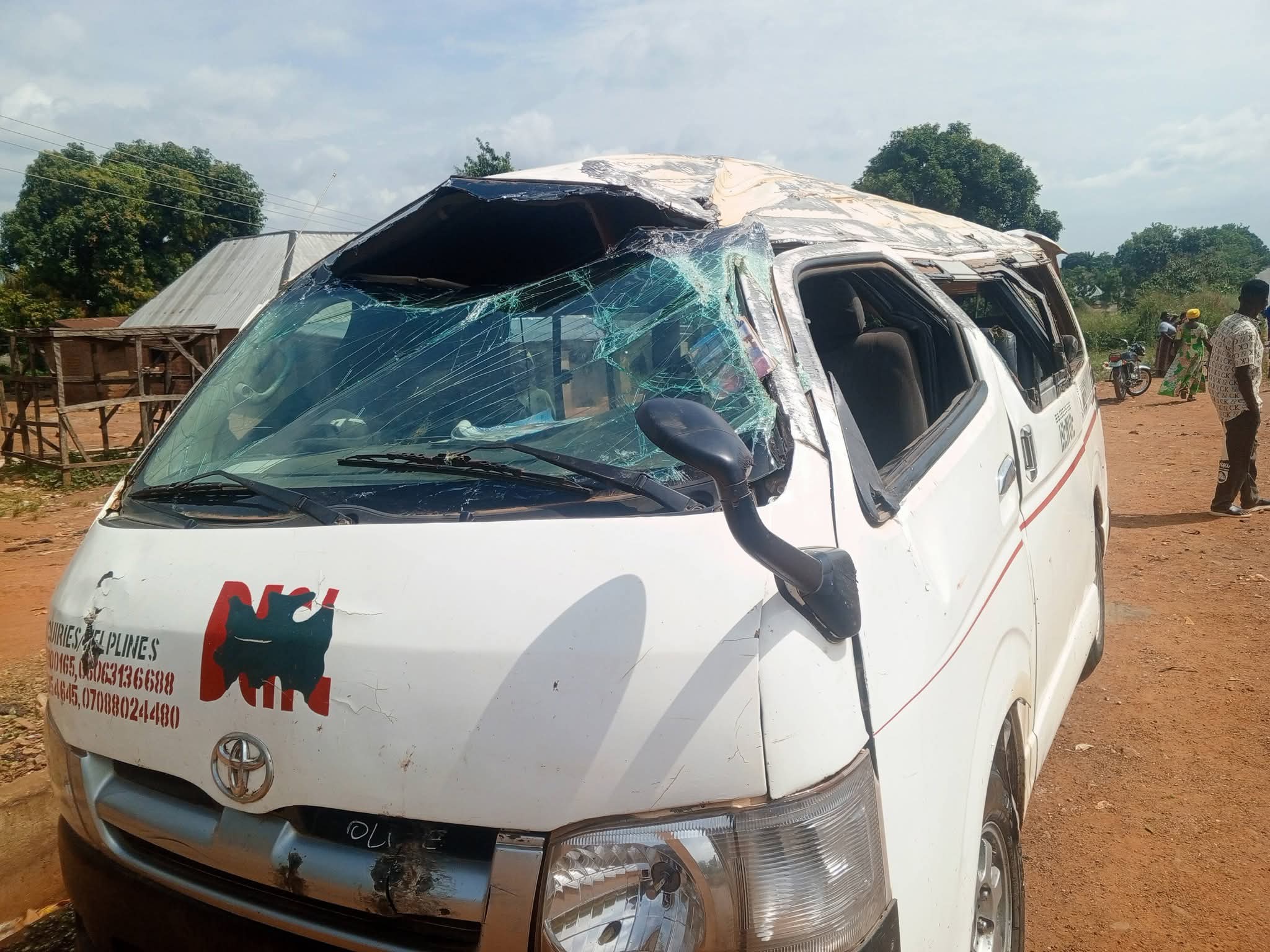 Wrecked white passenger bus with a crushed roof and shattered windscreen after the Benue Links bus accident in Ushongo, Benue State