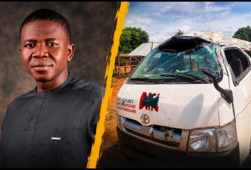 Aar Amos Terna, survivor of the Benue Links bus accident in Ushongo, beside the wrecked bus with a crushed roof and shattered windscreen